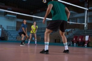 Full length of players practicing volleyball