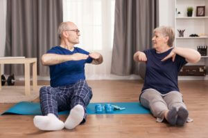 Senior couple doing back exercises