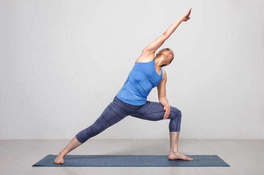 Woman doing Ashtanga Vinyasa yoga asana Utthita parsvakonasana