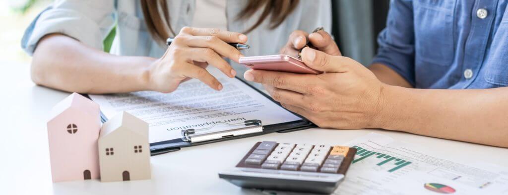 Young couple looking for comparison information on their decision to buy a new home