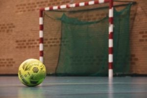 yellow and black soccer ball on field