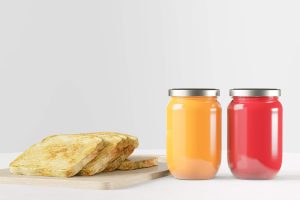 Strawberry jam and orange jam in a jar with toast