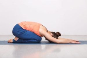 Woman relax in Hatha yoga asana Balasana child pose